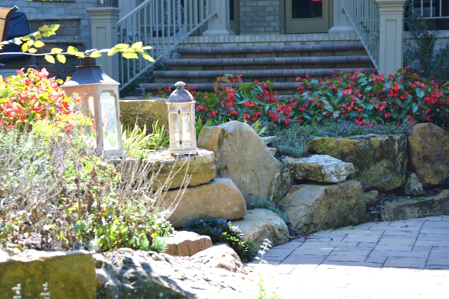 Hardscape stones and paver, surrounded by annual flowers and professional landscaping