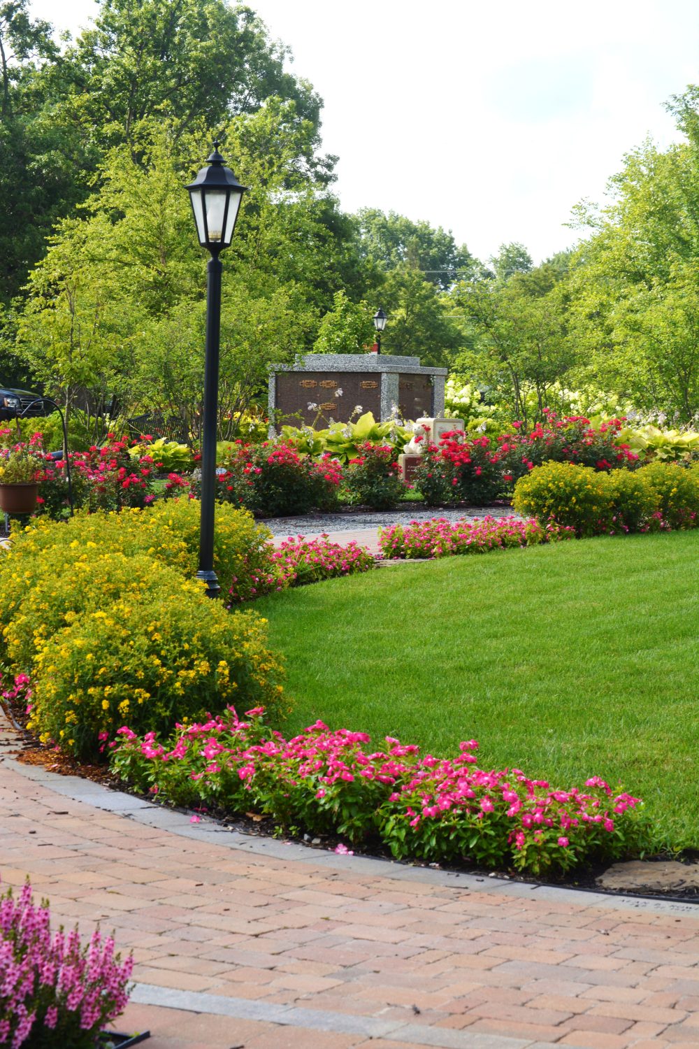 Brick walkway surrounded by planted flowers